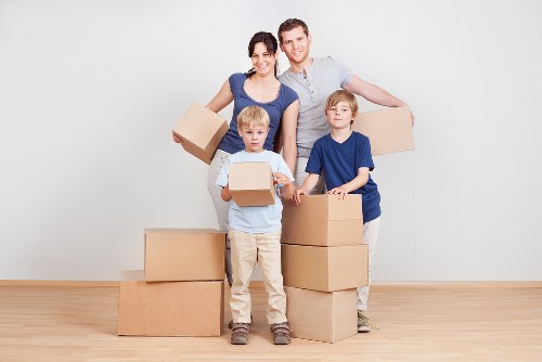 Professional mover loading household items for transport in Westgreen